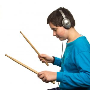 Boy with headphones listening to music isolated on white background