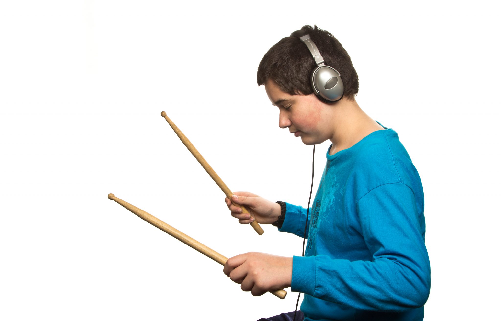 Boy with headphones listening to music isolated on white background